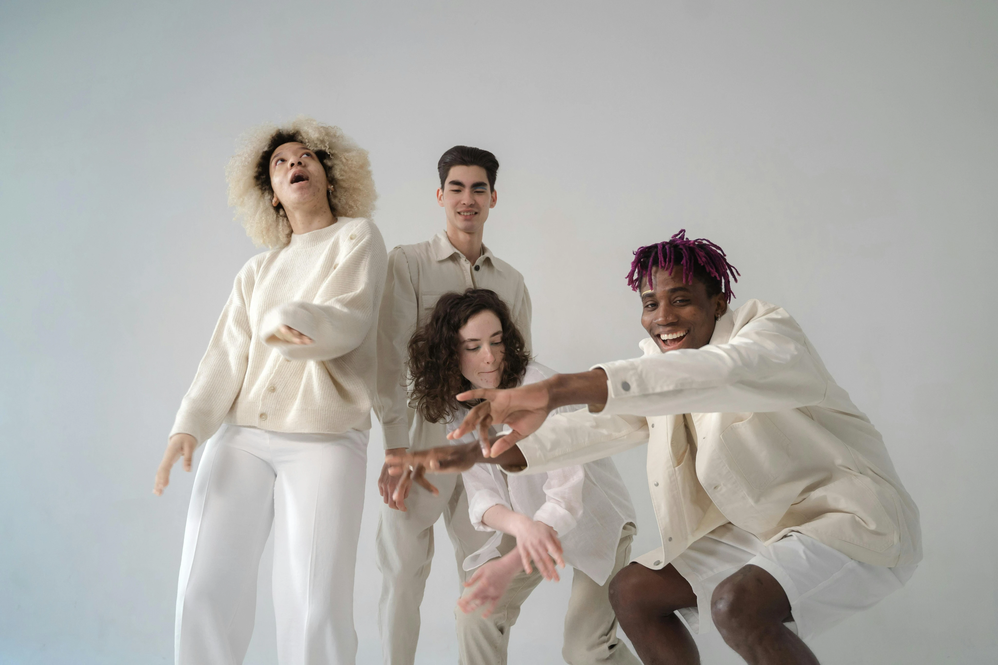 Models in white attire posing in grey backdrop